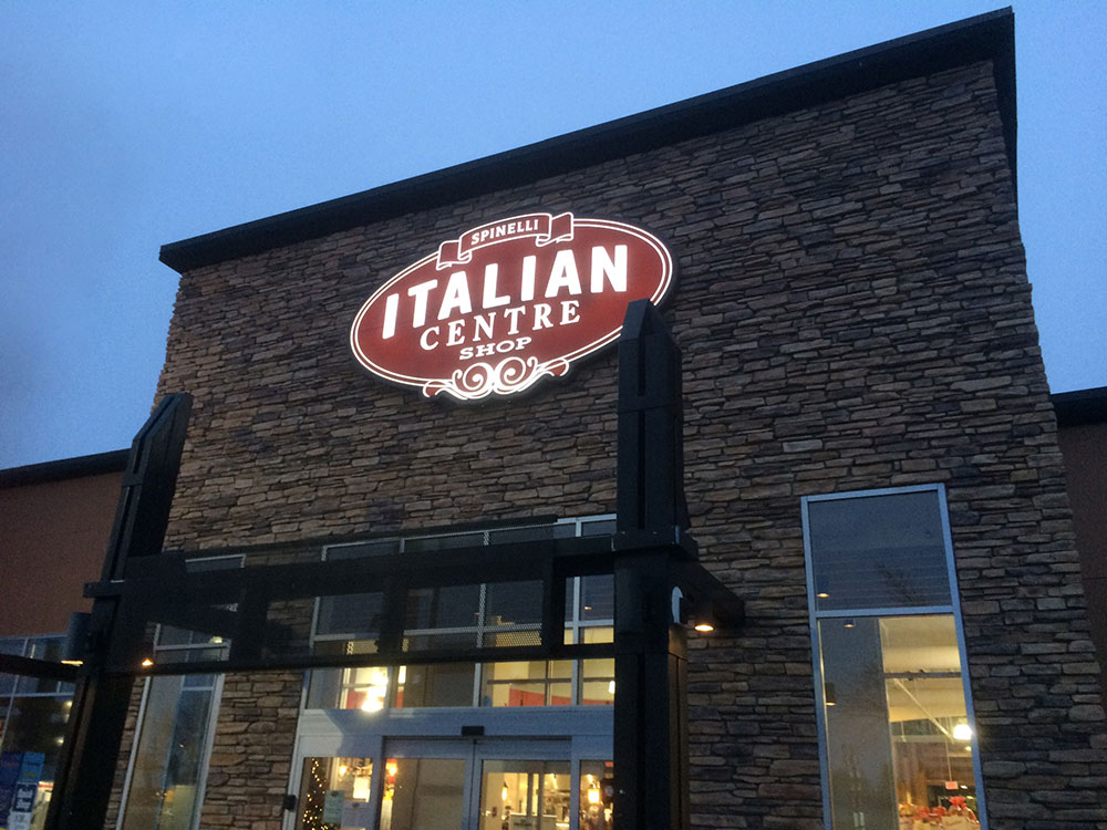 The Italian Centre Shop Sign lit up at night.