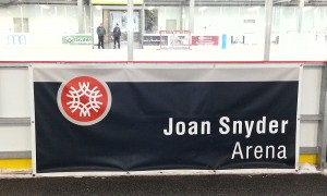 vinyl banner sign hung in a hockey rink