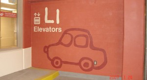 Example of parking lot sign that uses numbers, colors and shapes to help wayfinding