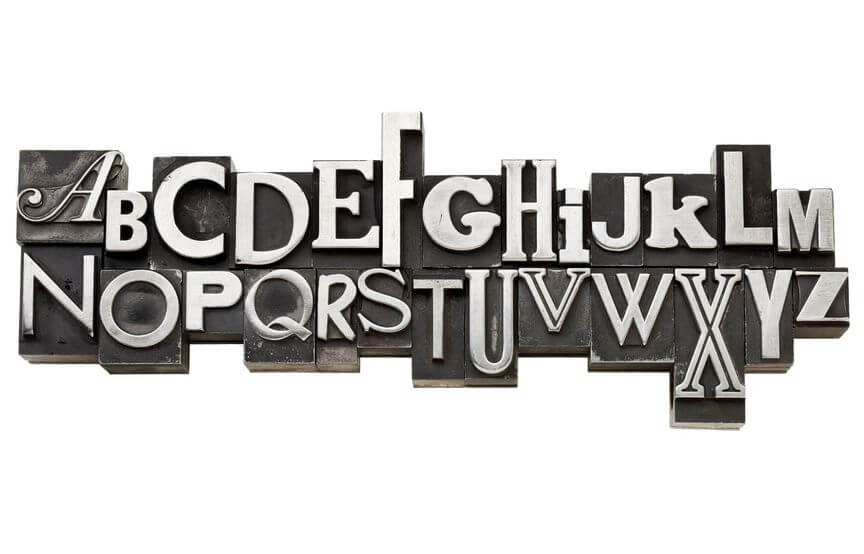 Cast metal type pieces of the alphabet in a variety of font styles